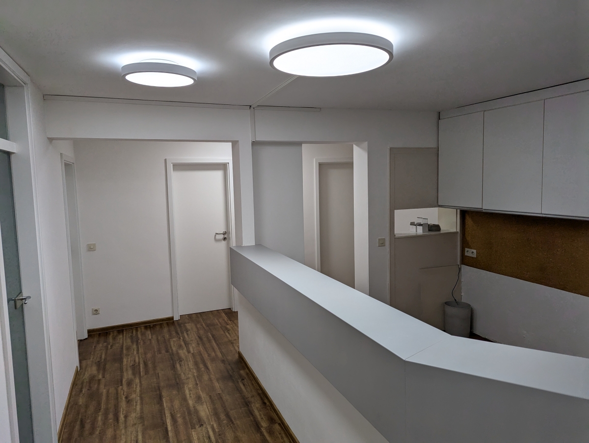 LED ceiling lights in a medical practice – reception and corridor with round LED fixtures